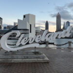 Cleveland script sign located at North Coast Harbor, with the downtown skyline in the background
