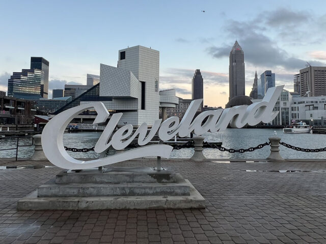 Cleveland script sign located at North Coast Harbor, with the downtown skyline in the background