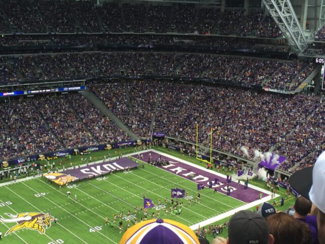 The Minnesota Vikings enter the field at U.S. Bank Stadium