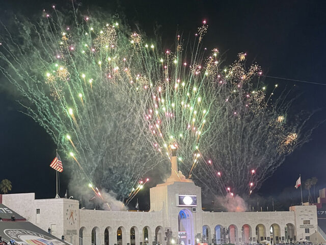 Fireworks go off behind the peristyle at the Los Angeles Memorial Coliseum
