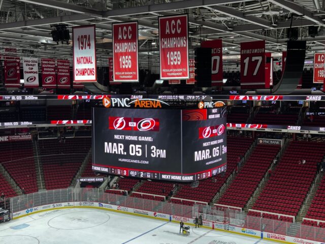 NC State Wolfpack and Carolina Hurricanes banners hang in the rafters at PNC Arena in Raleigh, North Carolina