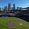 The downtown Minneapolis skyline is visible beyond the right-field bleachers at Target Field, home of the Minnesota Twins
