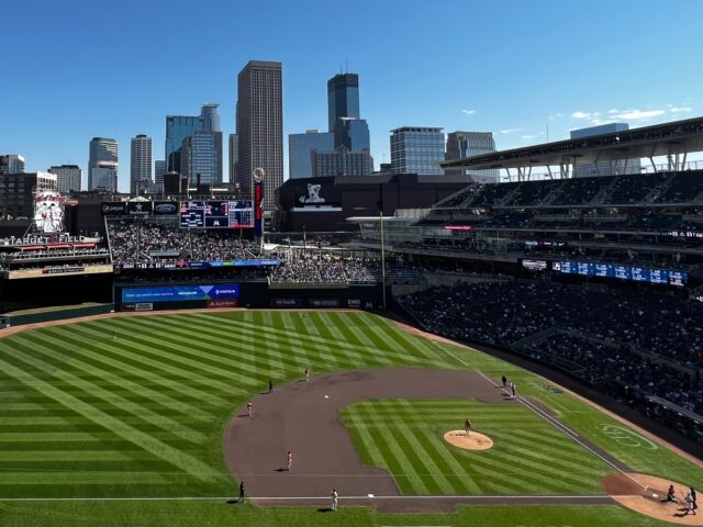 The downtown Minneapolis skyline is visible beyond the right-field bleachers at Target Field, home of the Minnesota Twins