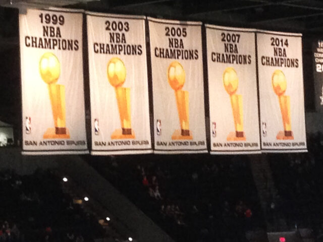 The San Antonio Spurs' championship banners hang from the rafters at Frost Bank Center