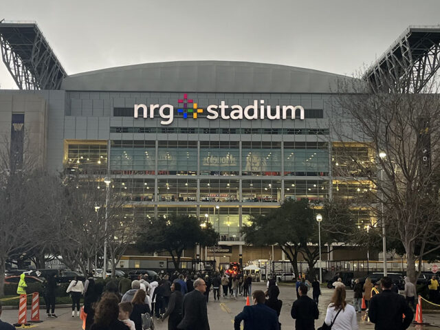Fans walk toward the entrance gates at NRG Stadium in Houston