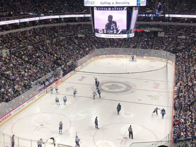 View of the rink from behind one of the nets at Canada Life Centre during a Winnipeg Jets game