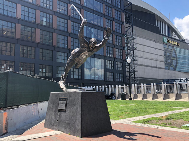 A statue of Bobby Orr in his famous Stanley Cup-winning goal pose stands outside TD Garden in Boston