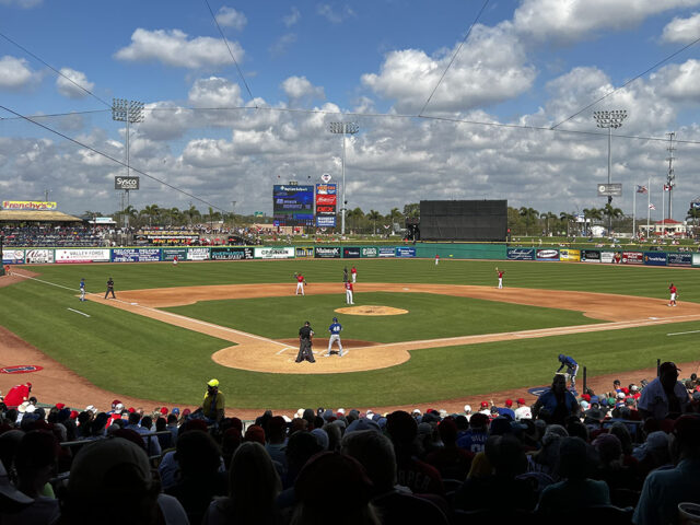 Players stand on the field during a spring training baseball game at BayCare Ballpark in Clearwater, Florida