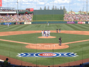 Players talk on the pitcher's mound during a spring training game at Sloan Park in Mesa, Arizona