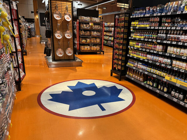 A blue Maple Leaf logo on the floor of the Loblaws grocery store in downtown Toronto signifies where center ice once was at Maple Leaf Gardens