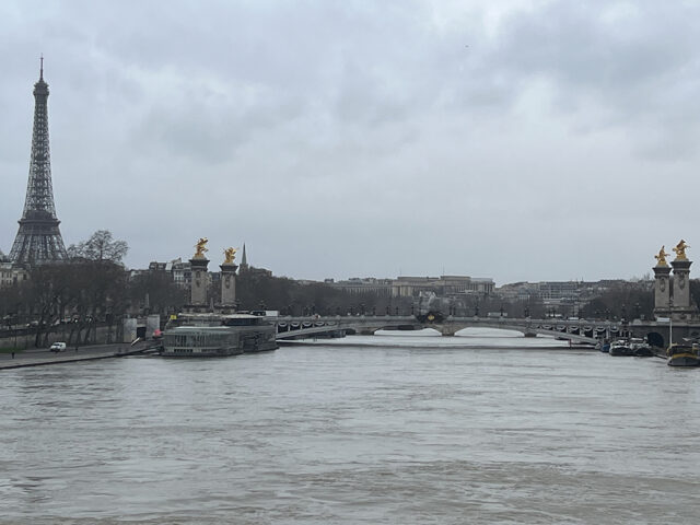 View of the Seine River in Paris, with the Alexandre III bridge and Eiffel Tower in the background