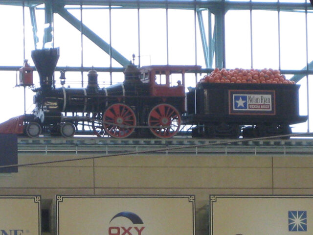 A train rides the tracks above the left-field stands at Houston's Daikin Park
