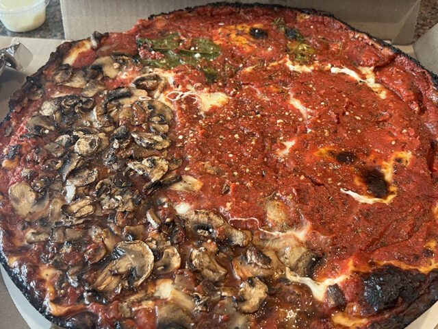 Deep-dish pizza in a takeout box from Pequod's Pizza in the Chicago area