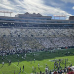 Players warm up on the field before a Colorado Buffaloes game at Folsom Field