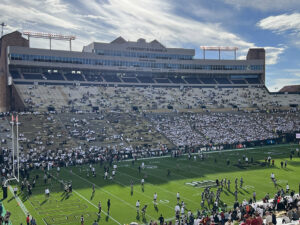 Players warm up on the field before a Colorado Buffaloes game at Folsom Field