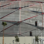 View of the Intuit Dome in Inglewood, with signage in front of the building