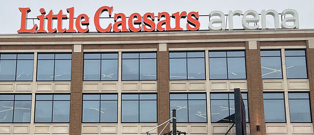 Signage posted atop the east side of Little Caesars Arena in Detroit