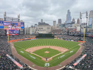 View of the field from behind home plate at Comerica Park, with the downtown Detroit skyline in the background
