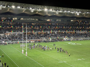 Players gather on the field after an NRL rugby match in Parramatta, Australia