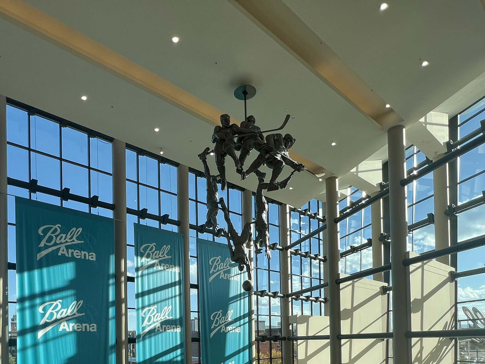 A unique sculpture hangs from the ceiling in the atrium of Ball Arena in Denver, Colorado