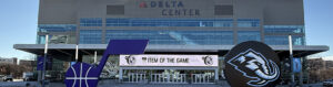 Utah Jazz and Utah Mammoth logos are displayed in front of the northeast entrance to the Delta Center in Salt Lake City