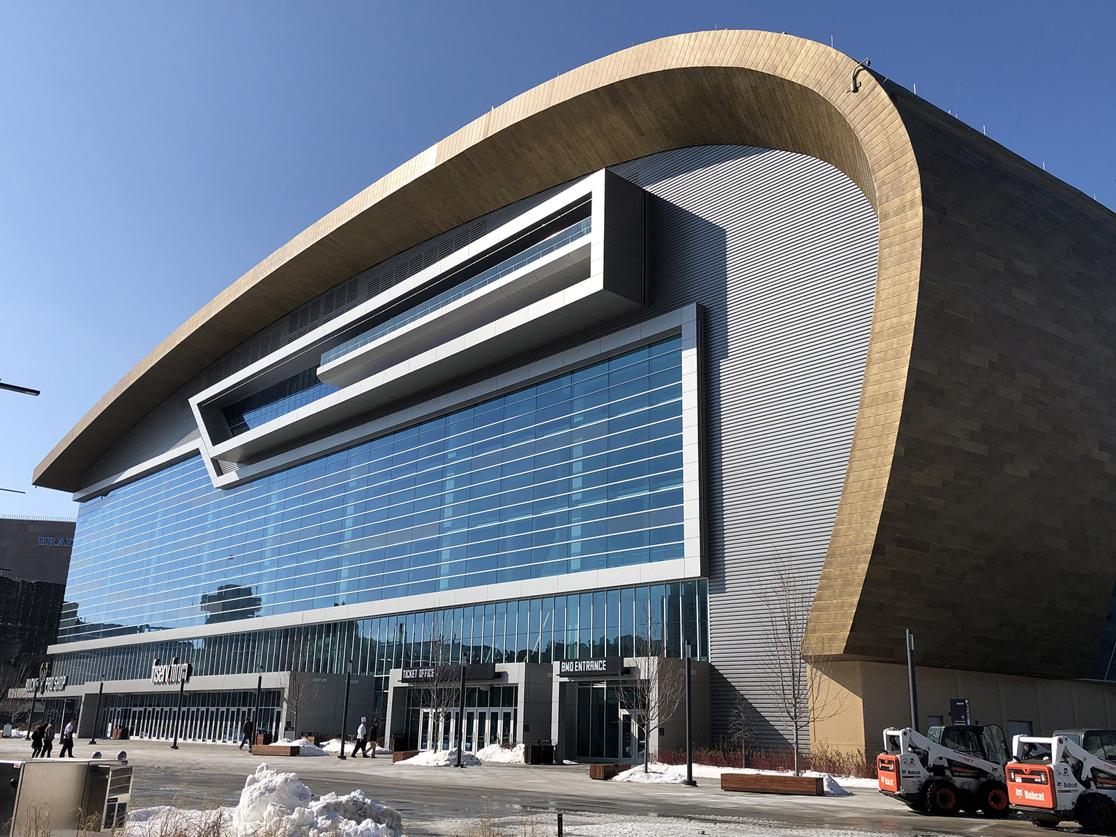 A curved roof marks the distinctive exterior of Fiserv Forum in Milwaukee, Wisconsin