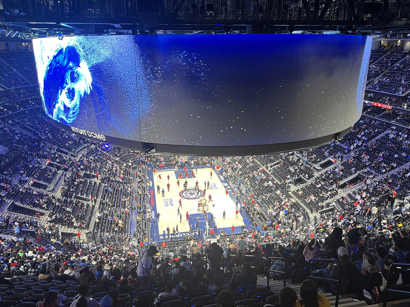 View of the court and oculus board from behind one of the baskets at the Intuit Dome in Inglewood, California