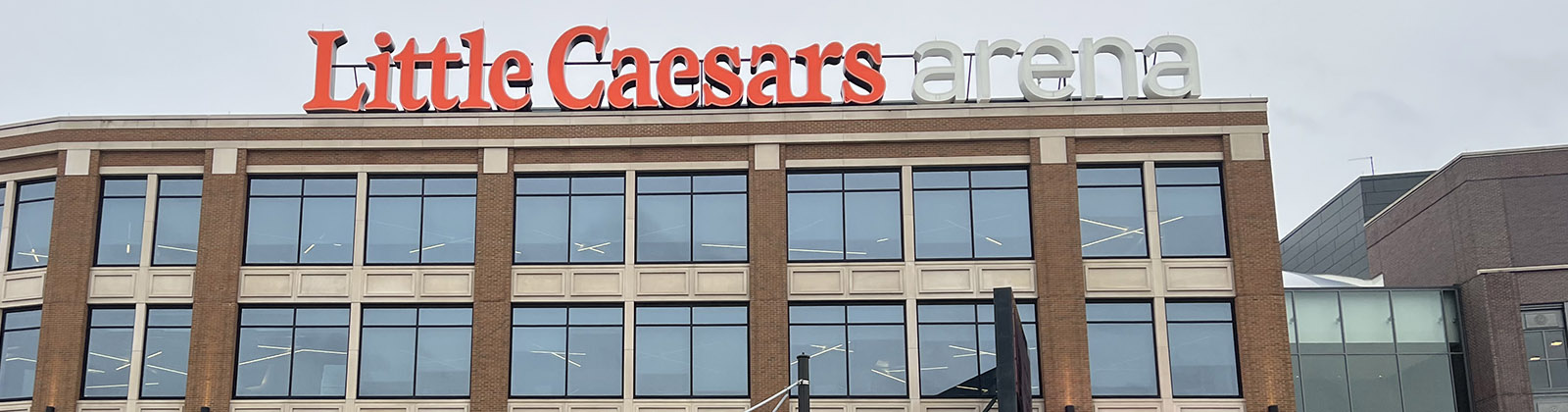 Signage posted atop the east side of Little Caesars Arena in Detroit, Michigan