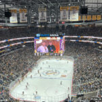 View of the rink and seating bowl from behind one of the nets at PPG Paints Arena in Pittsburgh, Pennsylvania