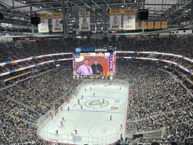 View of the rink and seating bowl from behind one of the nets at PPG Paints Arena in Pittsburgh, Pennsylvania