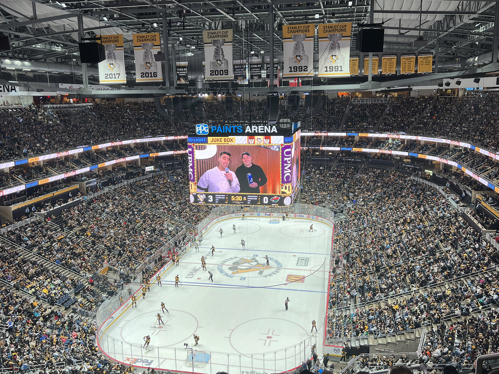 View of the rink and seating bowl from behind one of the nets at PPG Paints Arena in Pittsburgh, Pennsylvania