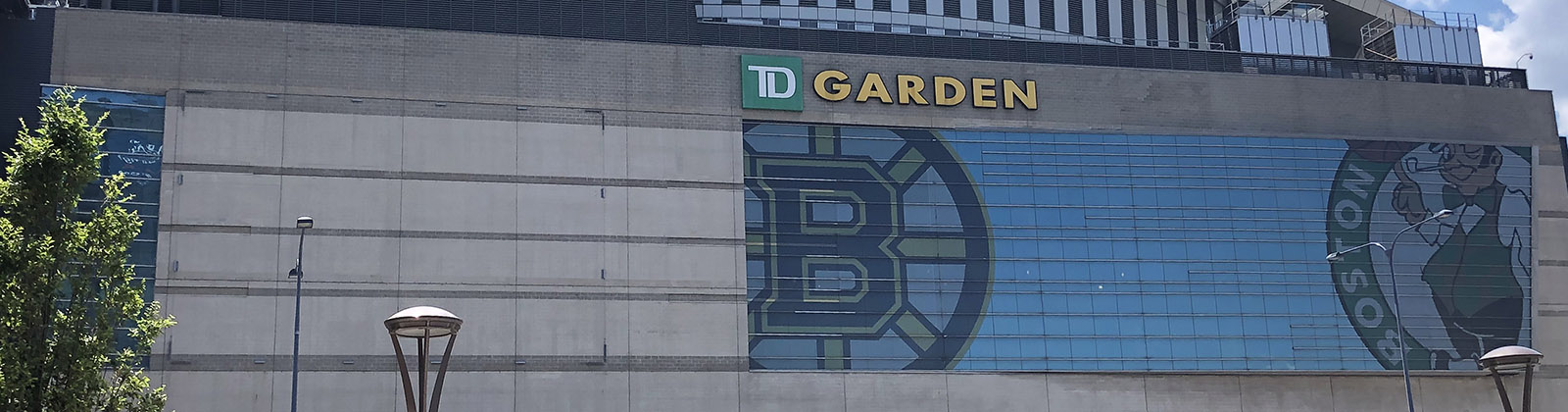 Panoramic view of the exterior of TD Garden in Boston, Massachusetts, with the Bruins and Celtics logos displayed