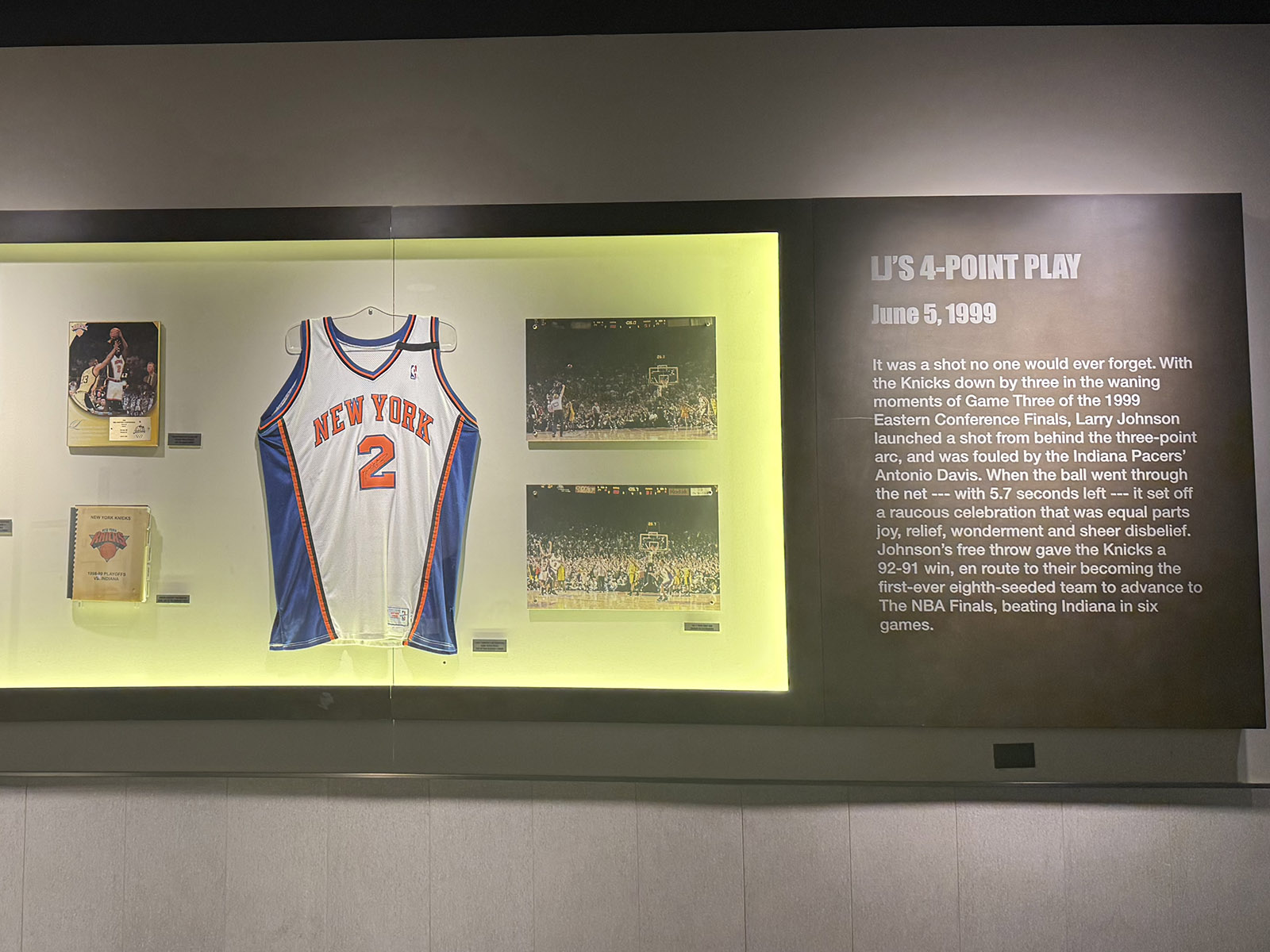 A Knicks jersey and photographs are part of a display on the concourse of Madison Square Garden in New York City
