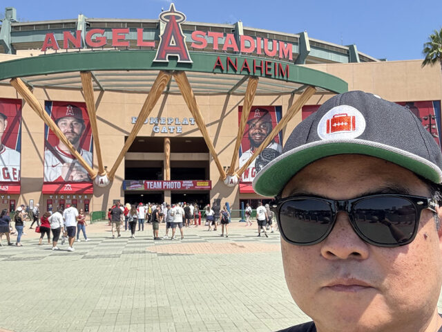 Man stands in front of the home plate entrance at Angel Stadium of Anaheim
