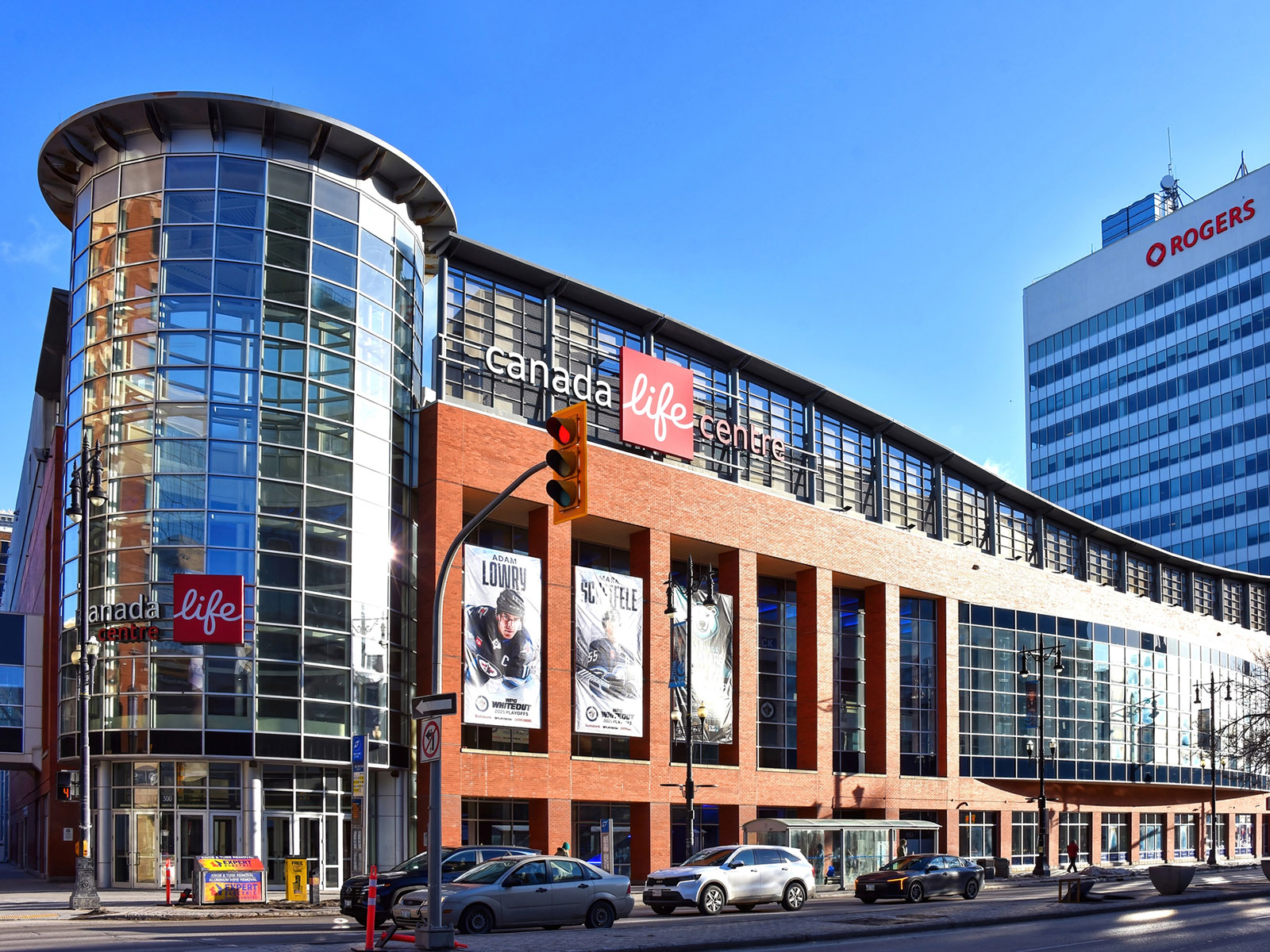 Exterior of Canada Life Centre in Winnipeg, Manitoba, Canada, with a distinctive circular glass atrium on the corner