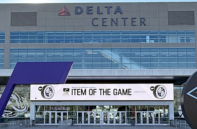 Panoramic view of the exterior of the Delta Center in Salt Lake City, Utah, with the Utah Jazz and Mammoth logos displayed in front