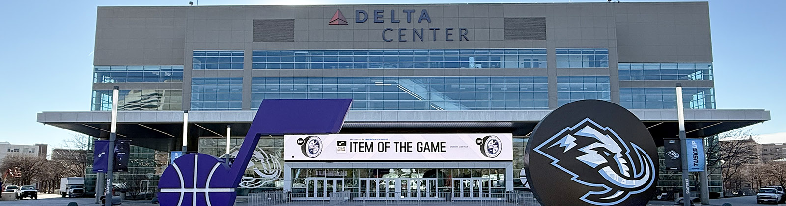 Panoramic view of the exterior of the Delta Center in Salt Lake City, Utah, with the Utah Jazz and Mammoth logos displayed in front