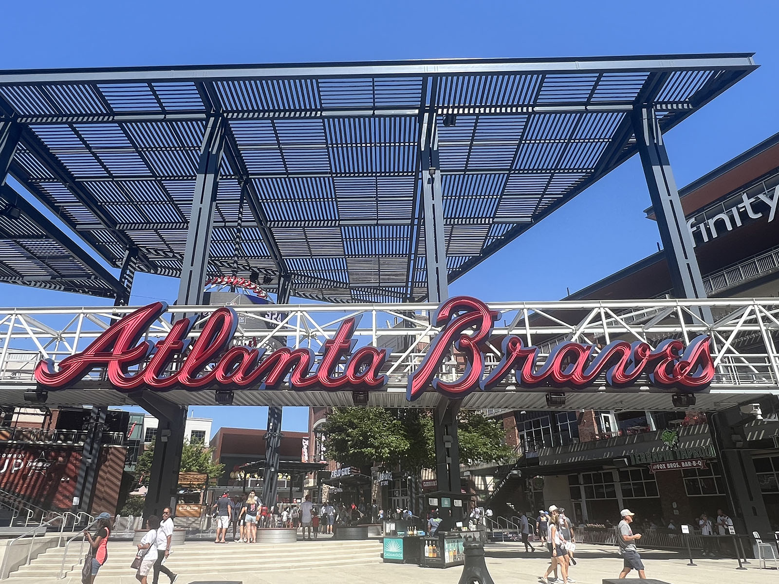 Atlanta Braves signage hangs above an entrance gate to Truist Park