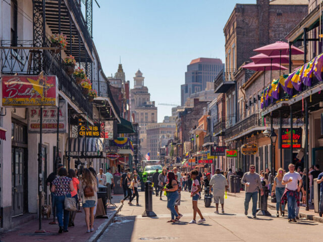 People walk along Bourbon Street in the French Quarter of New Orleans