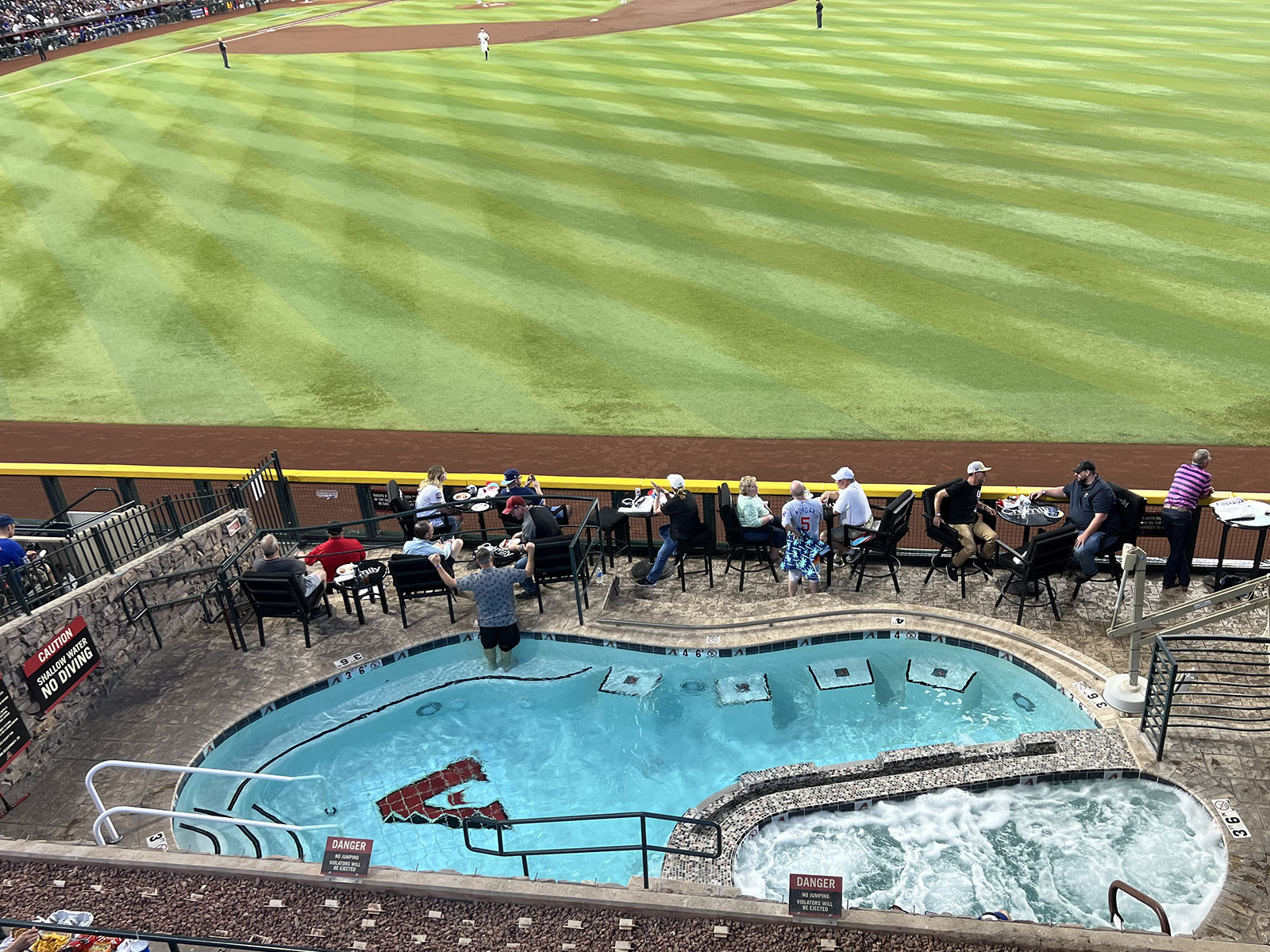 Fans watch an Arizona Diamondbacks game from the pool in right field at Chase Field in Phoenix, Arizona