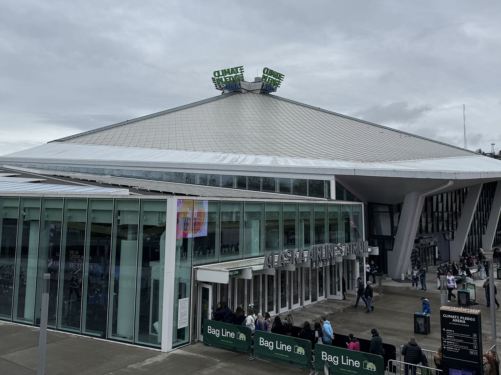 Exterior view of Climate Pledge Arena in Seattle, Washington, with the Alaska Airlines Atrium in the foreground