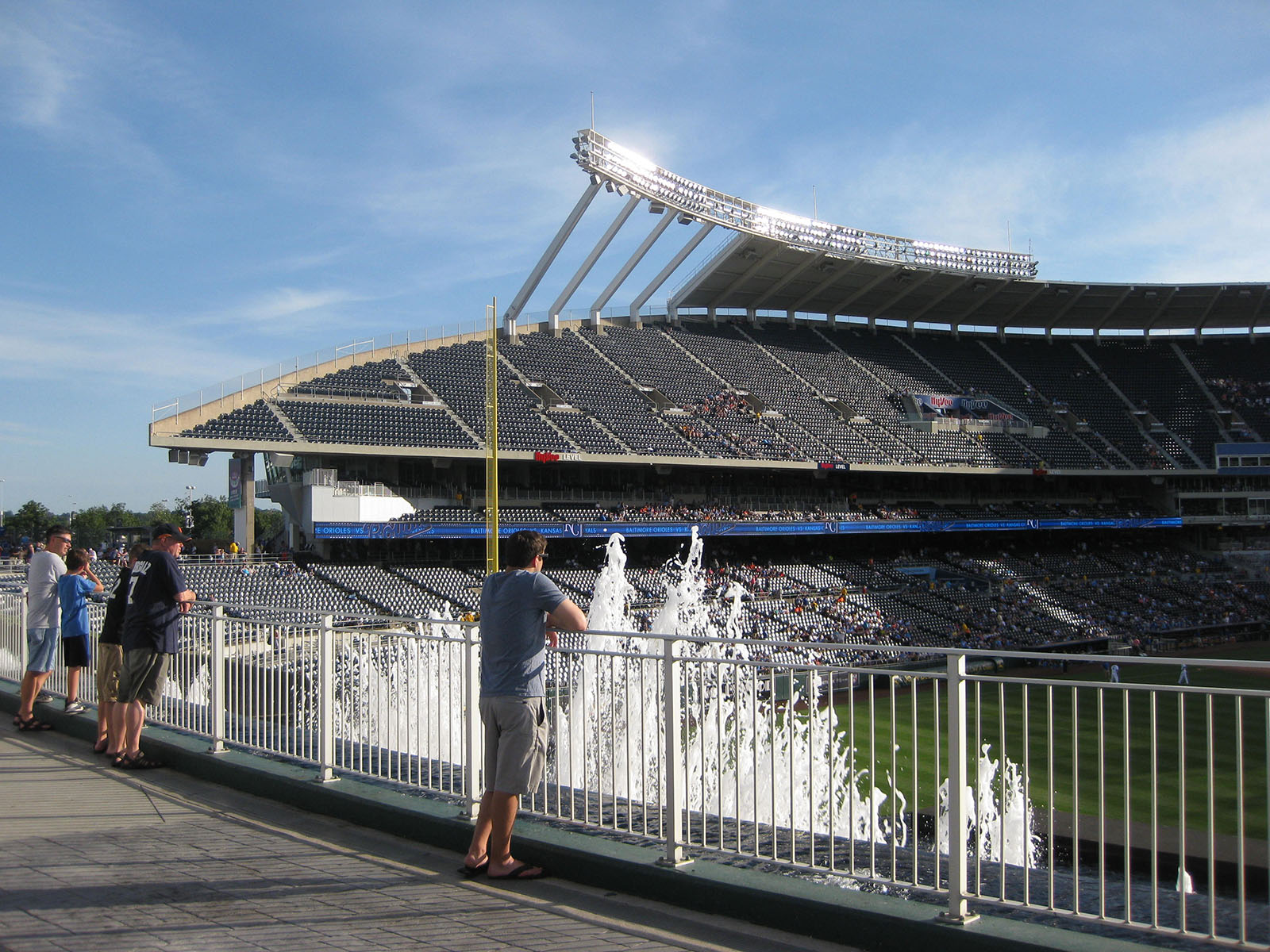 Fans watch a Kansas City Royals baseball game from behind the outfield fountains at Kauffman Stadium