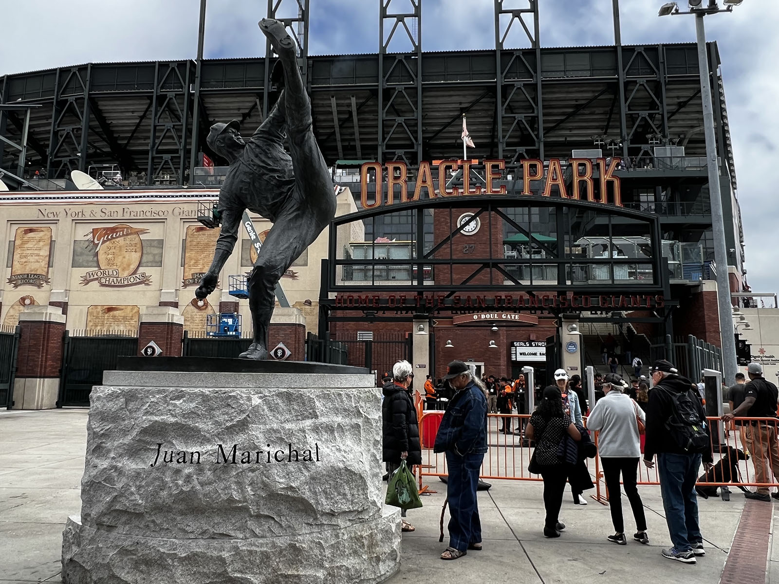 A statue of pitching great Juan Marichal stands in front of an entry gate at Oracle Park in San Francisco