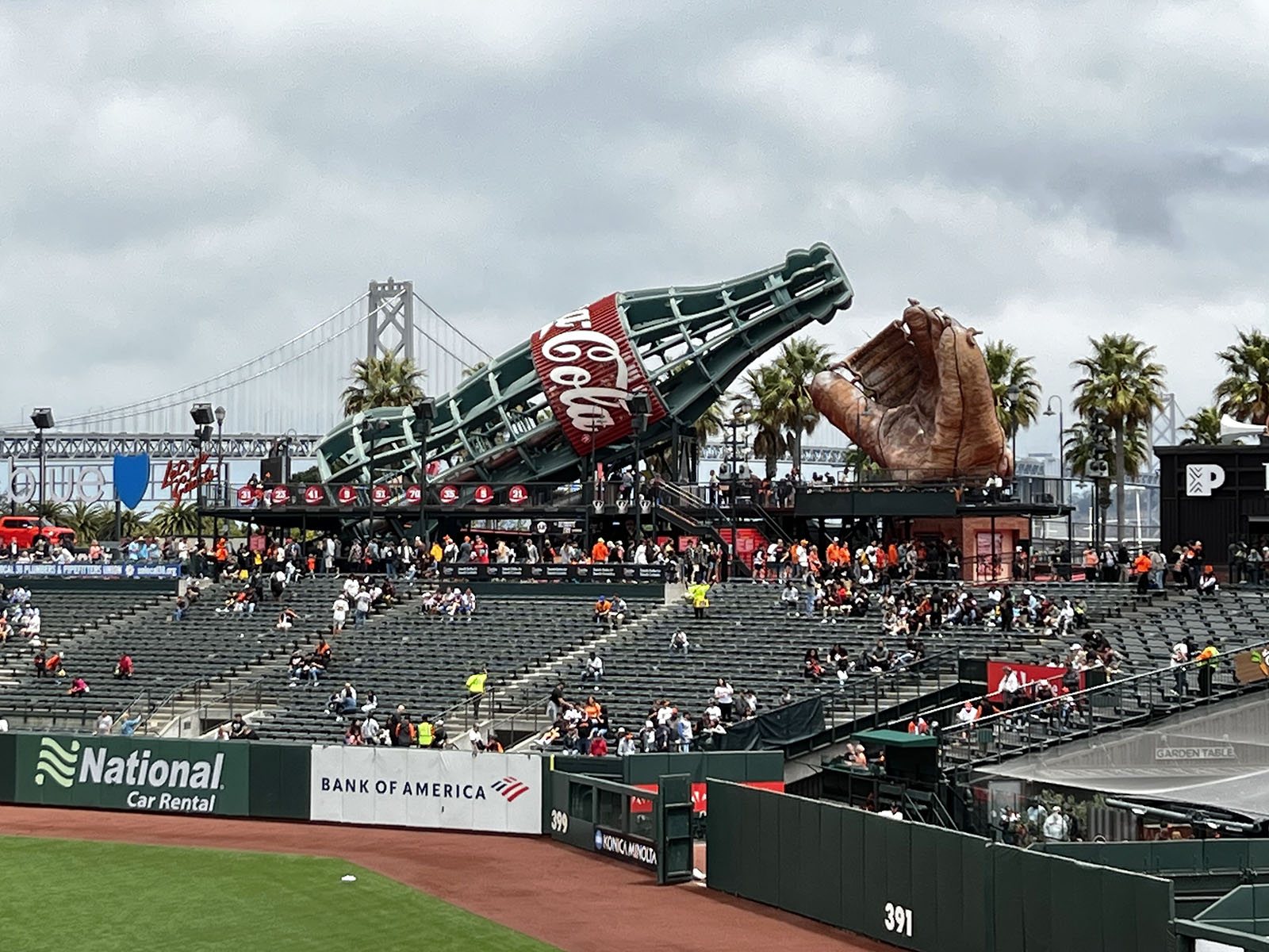 A large Coke bottle and baseball glove are highlights of the left-field bleachers at Oracle Park in San Francisco