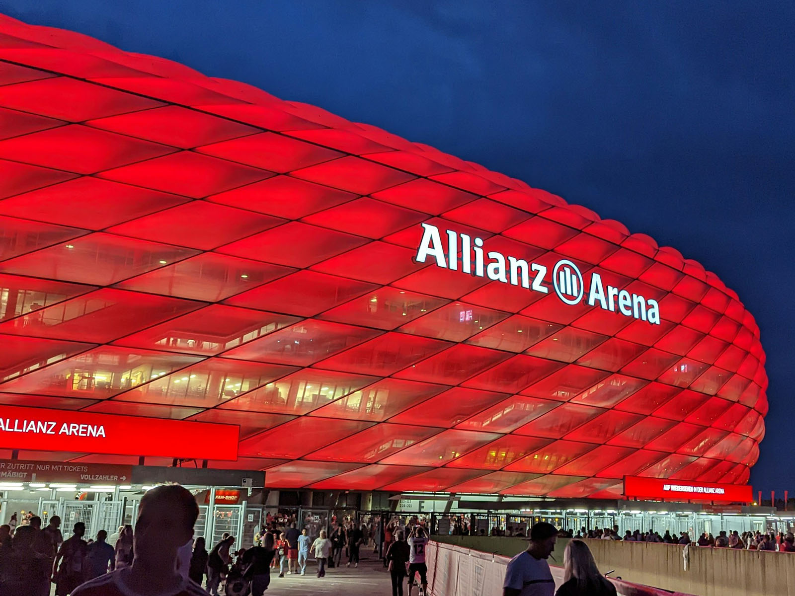 Exterior view of Allianz Arena in Munich, Germany, lit up in red for a Bayern Munich match