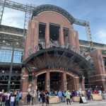 Baseball fans wait to enter Coors Field in Denver before a Colorado Rockies game