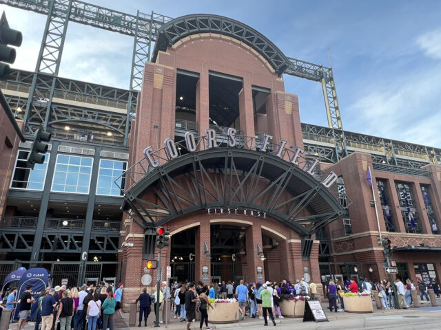 Baseball fans wait to enter Coors Field in Denver before a Colorado Rockies game