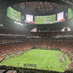View of the field and seating bowl from behind one of the end zones at Mercedes-Benz Stadium in Atlanta, Georgia