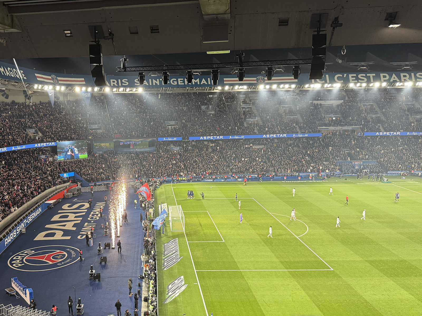 Fireworks shoot from behind the pitch to celebrate a Paris Saint-Germain goal during a football match at the Parc des Princes in Paris, France