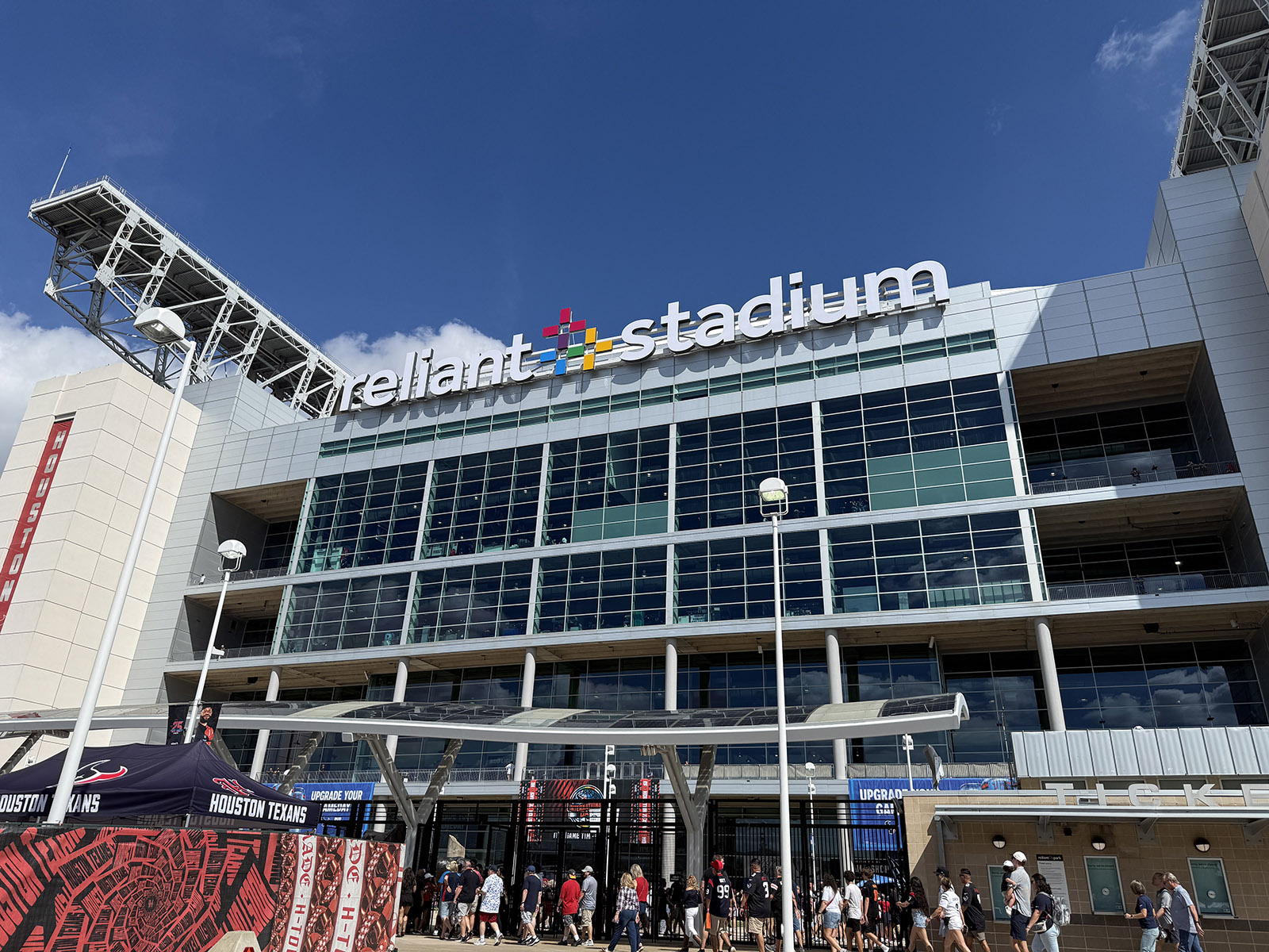 Exterior signage atop the glass façade at Reliant Stadium in Houston, Texas